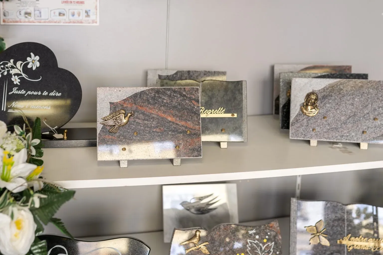 Exposition de plaques funéraires gravées et personnalisées en magasin.